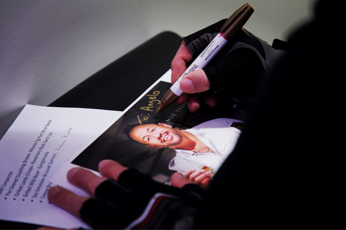 Moe signing a Moe Train photo for a fan