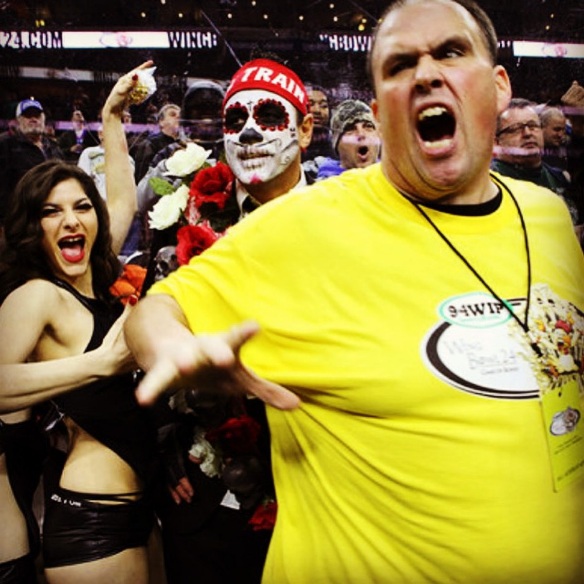 Moe in sugar skull paint behind a cheering Wing Bowl crowd in 94WIP shirts