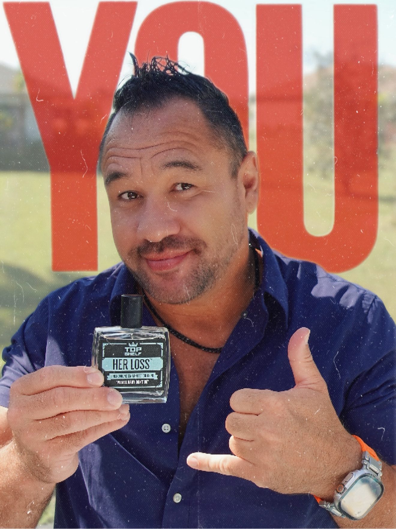 Moe outdoors holding a Top Shelf Her Loss cologne bottle and giving a shaka sign