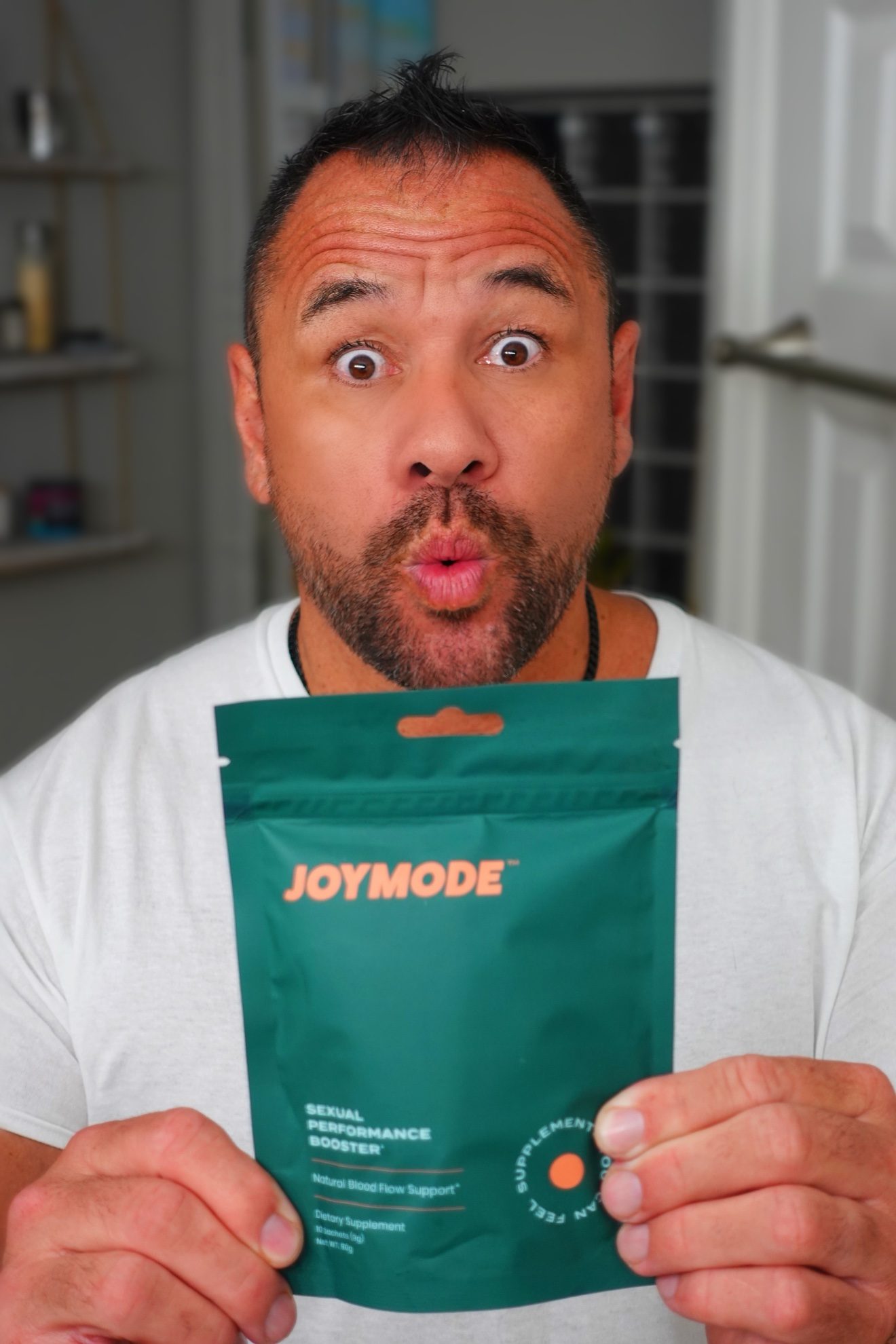 Moe holding a JoyMode packet and reacting with a surprised expression